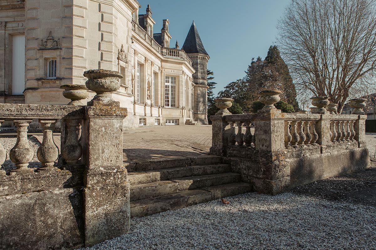 A woman is holding a surfboard on the beach